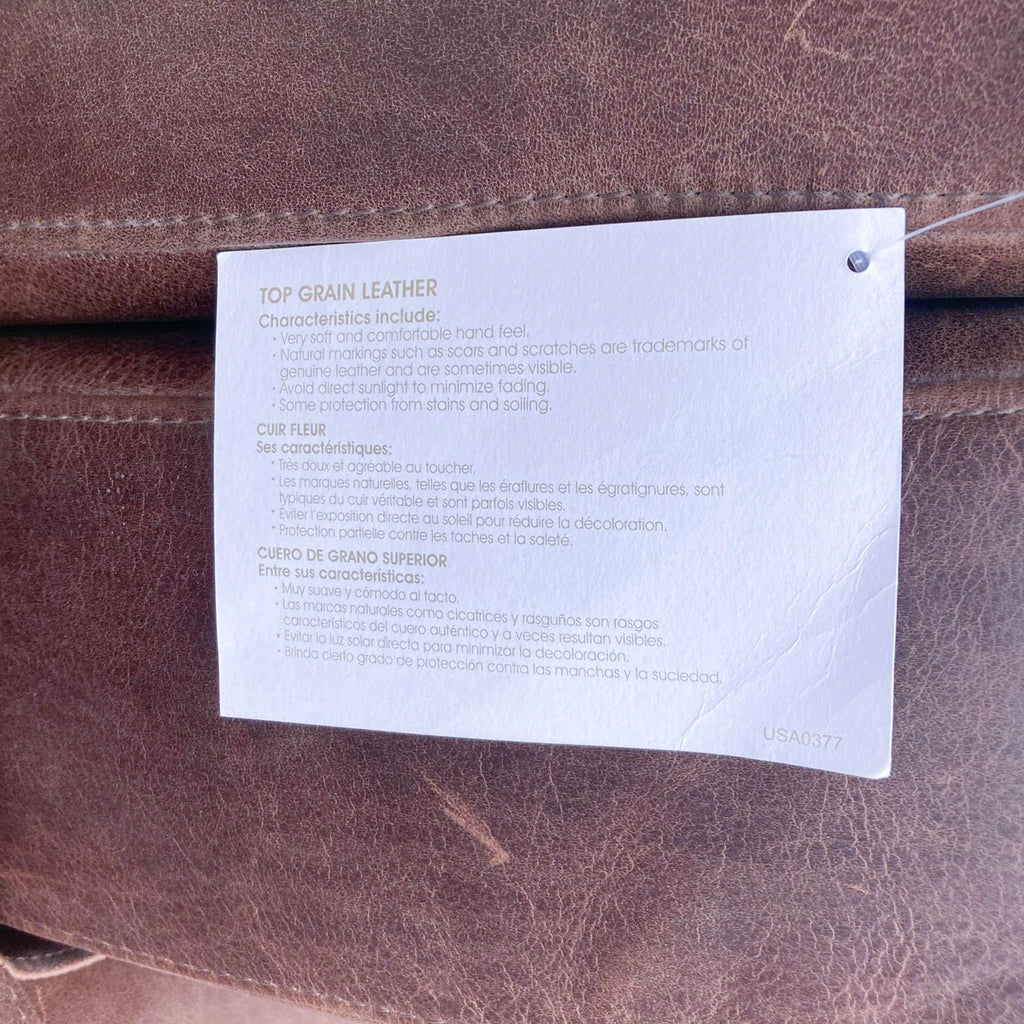 Close-up of top grain leather tag detailing characteristics for a West Elm sectional.