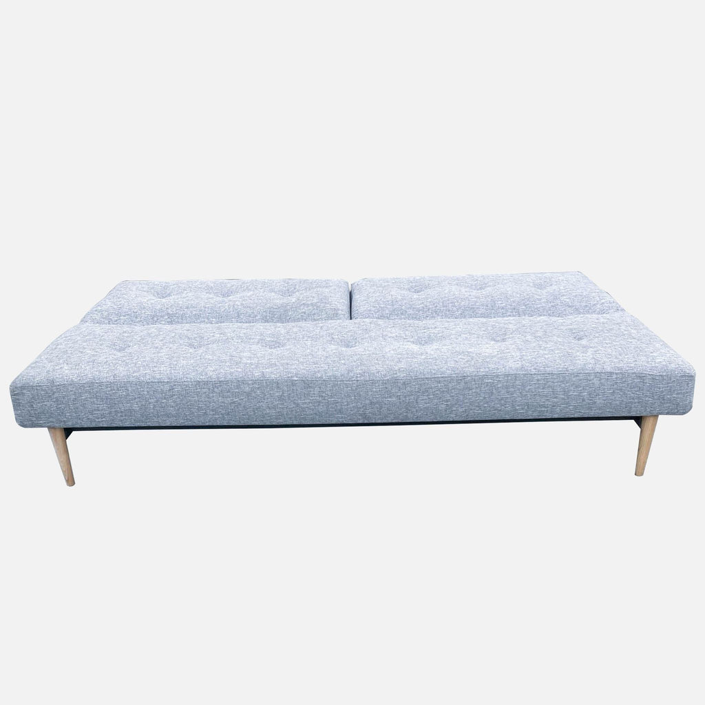 Reperch Sleeper Sofa folded down into a bed with gray fabric and button details, showing its multi-functionality.