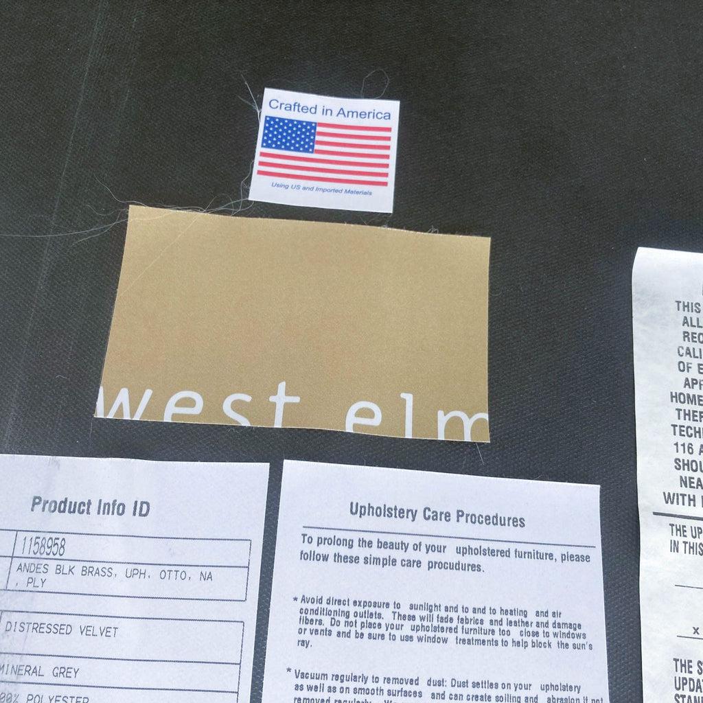West Elm label showing American craftsmanship on the underside of a modern velvet square ottoman.