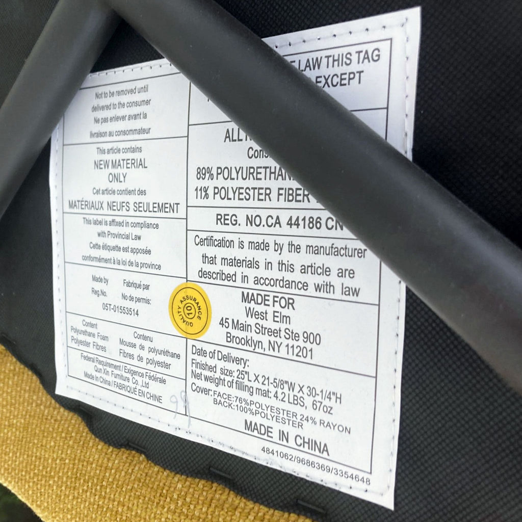 Label under chair showing materials and manufacturer info.