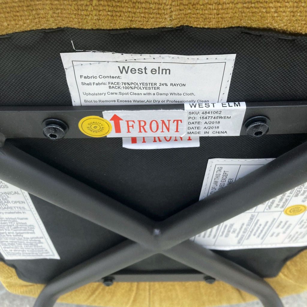 Chair bottom with West Elm label and care instructions.