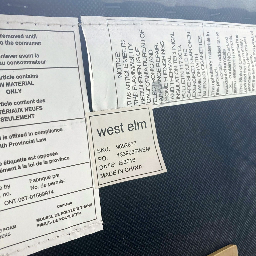 3. Product tag showing "west elm" brand and manufacturing details, attached to the lounge chair's underside.