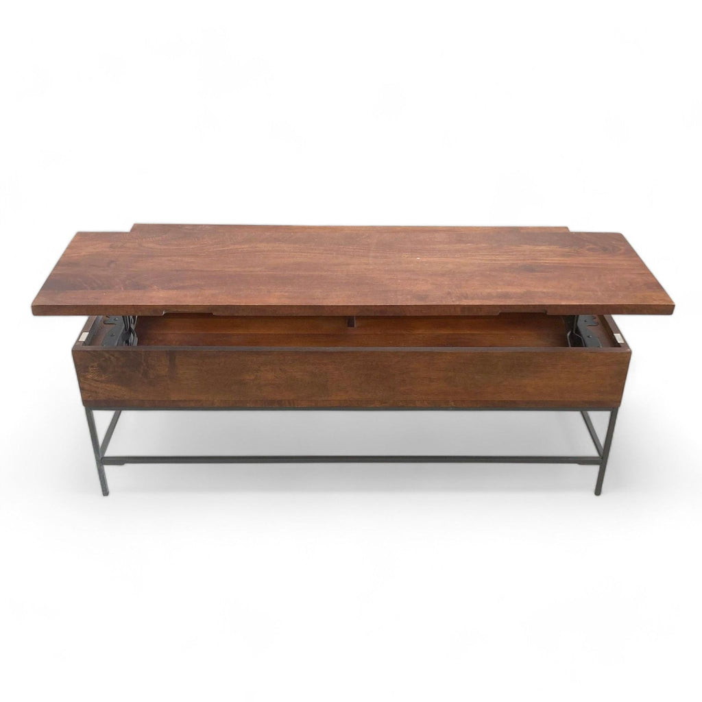 Williams Sonoma lift top coffee table open, revealing storage space, with metal frame, on plain background.