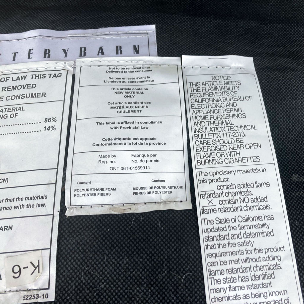 3. "Product labels and care instructions for a Pottery Barn leather ottoman, detailing material composition."