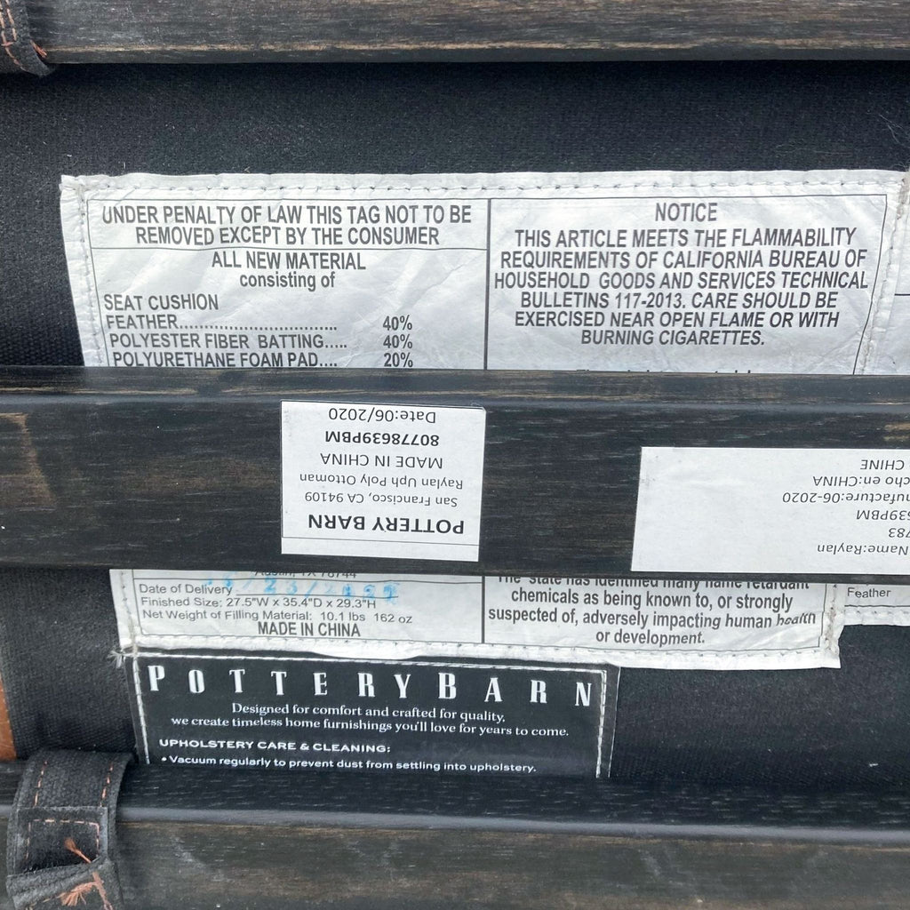 2. "Close-up of label on Pottery Barn ottoman detailing materials and flammability notice."