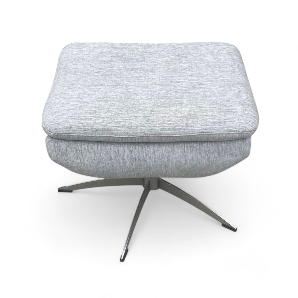 3. Padded grey fabric ottoman featuring lift top storage sitting on a chrome X-shaped base, from Target's furniture collection.