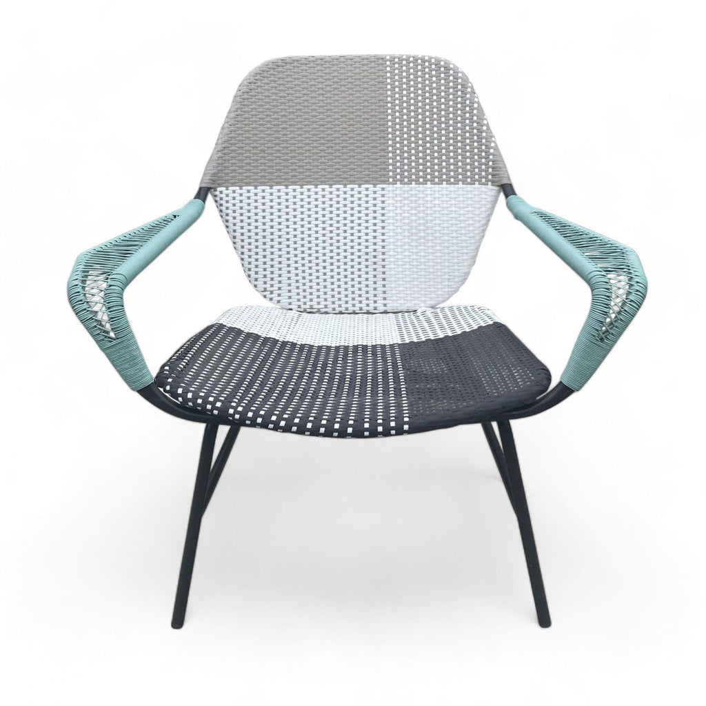 Whimsical outdoor chair with a color block pattern, resin wicker, and metal frame. West Elm brand.