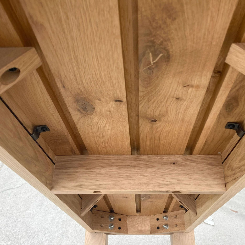 3. Underside view of a Crate and Barrel wooden bench showing the sturdy construction and wood joinery.