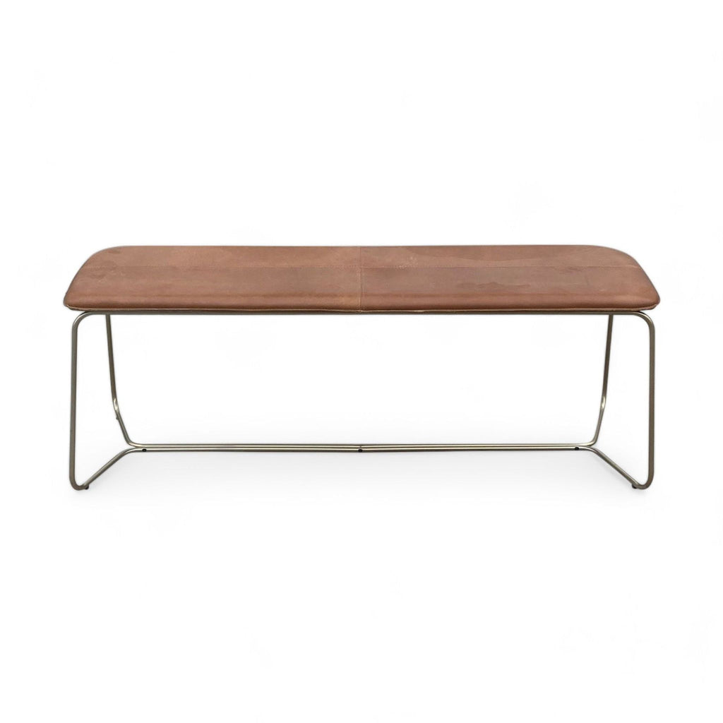 1. "West Elm bench with sleek chrome frame and smooth brown leather cushion on a white background."