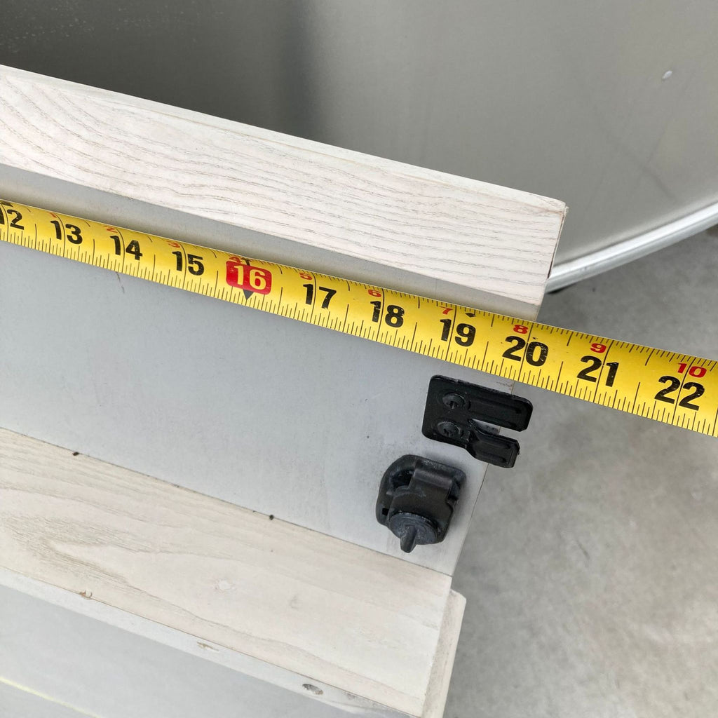 Measuring tape extending over a 20-inch drop-in leaf on the Mid Century Expandable dining table by West Elm.