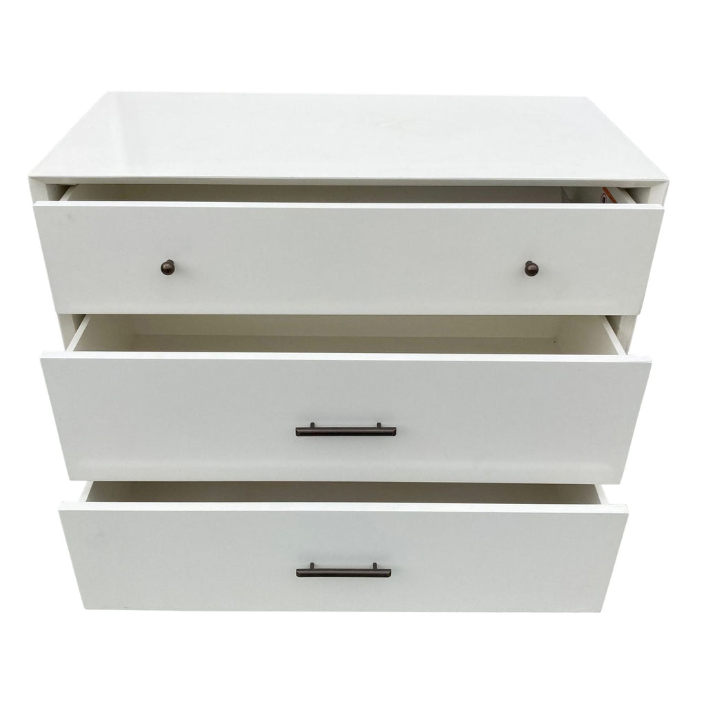 2. Open drawers of a West Elm dresser against a white background showcasing storage space.