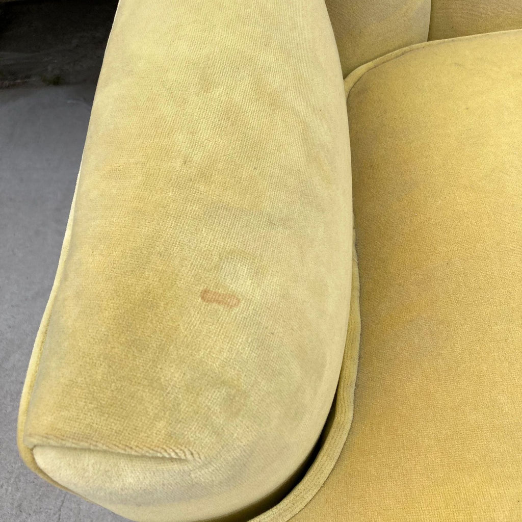 Close-up of a yellow upholstery stain on a Reperch barrel back accent chair's cushion.