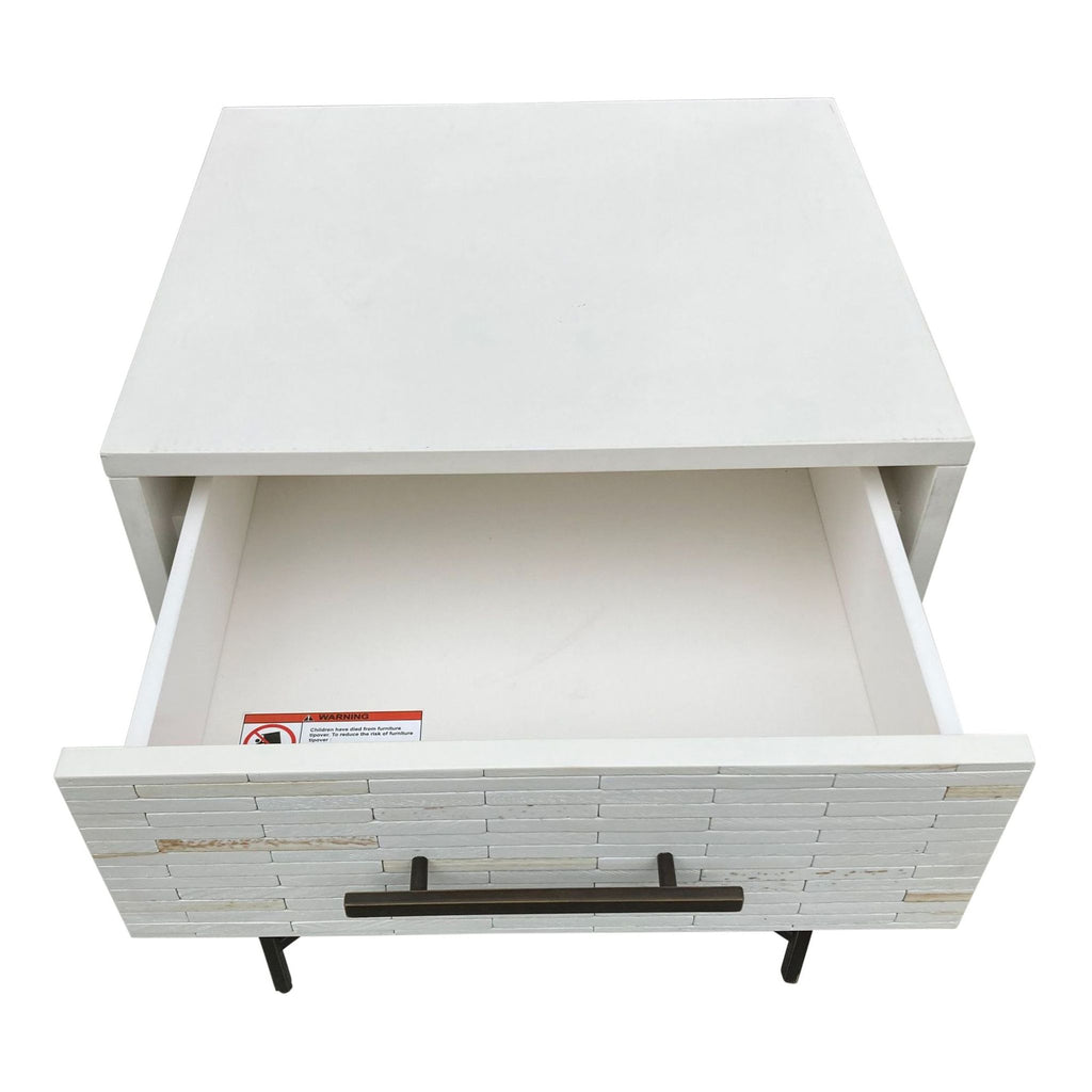 Top view of a West Elm white tiled end table showing the open drawer with a safety warning label inside.