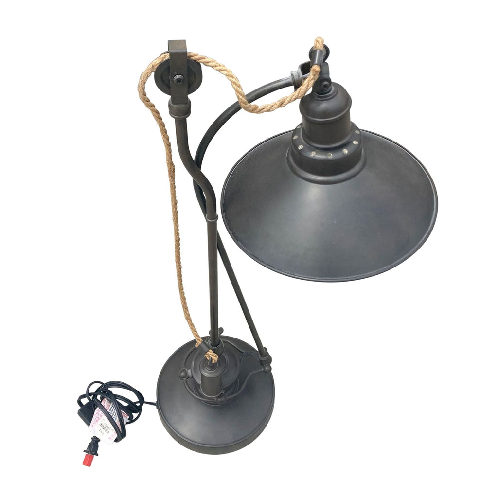 Top-down view of Reperch desk lamp showing black shade, curved neck, braided cable, and circular base.