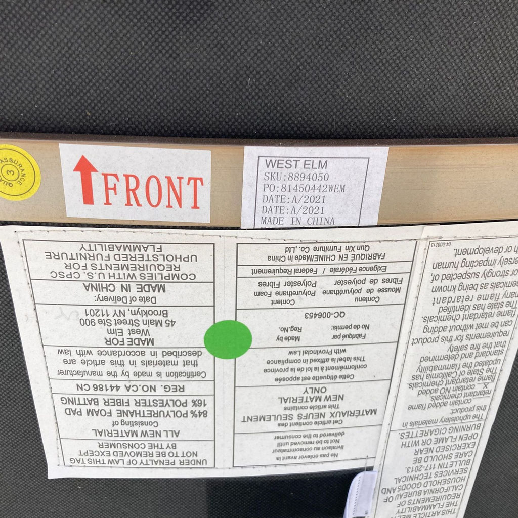 Label showing the West Elm brand, SKU, and manufacturing details on the underside of a dining chair.