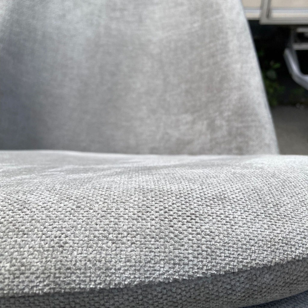 2. Close-up texture detail of the West Elm Finley dining chair's gray fabric, highlighting the quality and weave of the material.