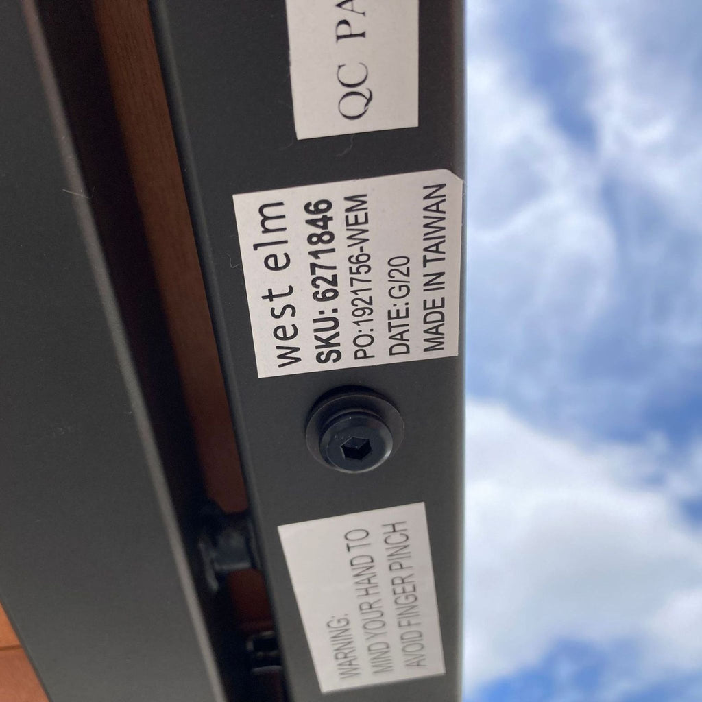 Table underside showing West Elm label with manufacturing details.