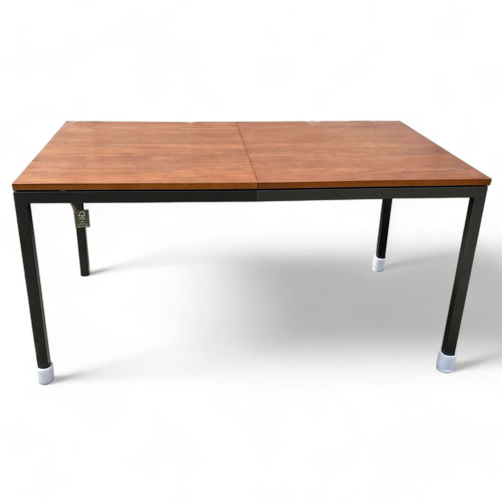 West Elm expandable dining table with walnut veneer on steel base, shown closed.