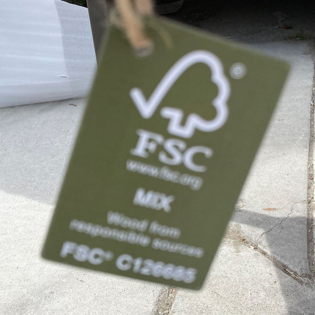 Close-up of FSC certification tag indicating responsible wood sourcing.