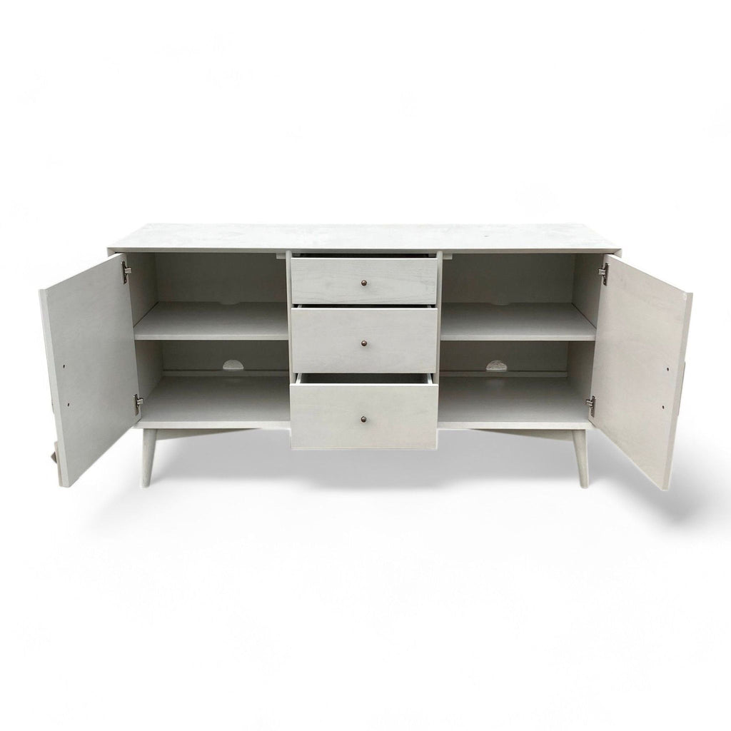 Open West Elm console showing shelves and drawers for storage.