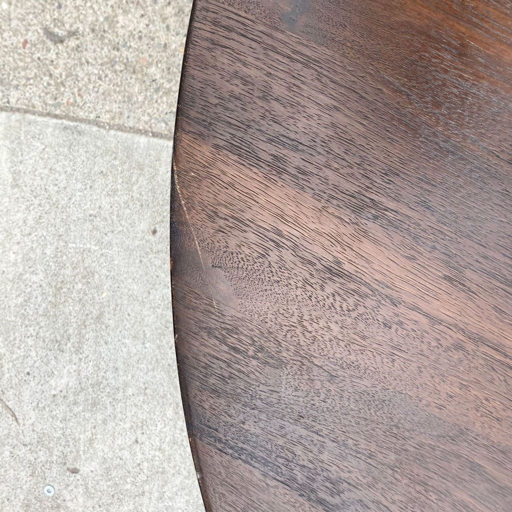 Close-up texture of the dark walnut coffee table surface.