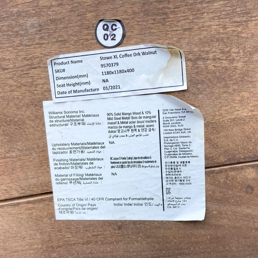 Product label indicating "Stowe XL Coffee Drk Walnut", materials, and date of manufacture for West Elm table.