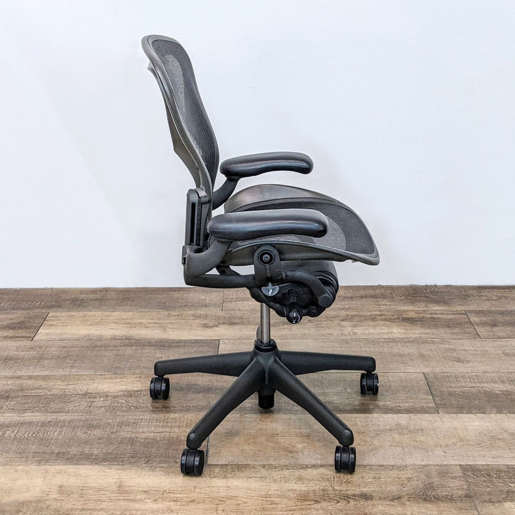 Side profile of a medium size B Aeron chair by Herman Miller with height and tilt adjustment features.