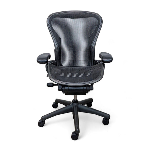Herman Miller Aeron office chair in black, showcasing adjustable arm rests and lumbar support.