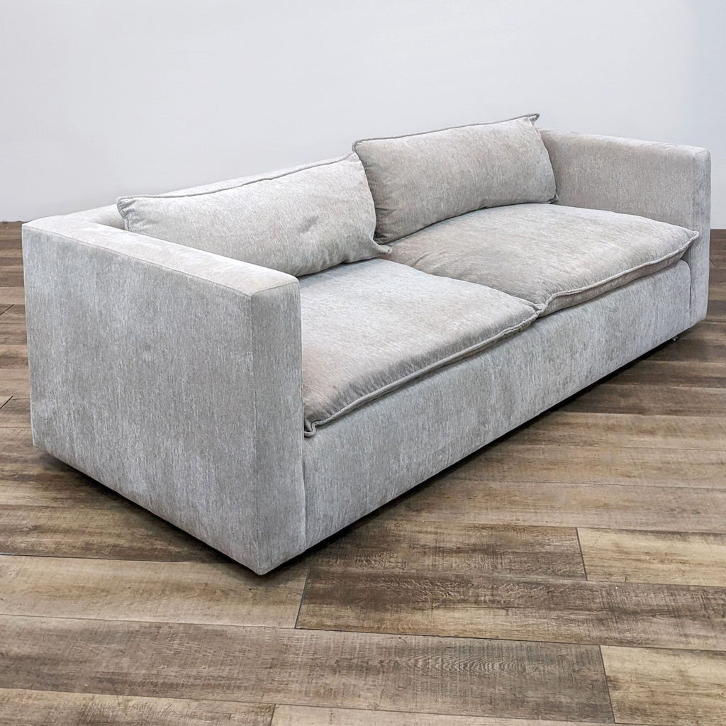 2. Modern 3-seater sofa in dove grey fabric, featuring shelter frame arms and comfortable down blend cushions.