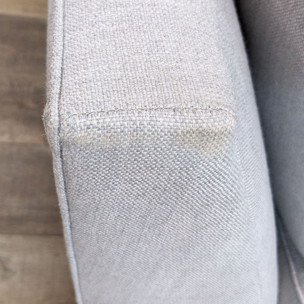 3. "Close-up texture of ash performance Sunbrella upholstery on Pottery Barn sectional sofa arm."