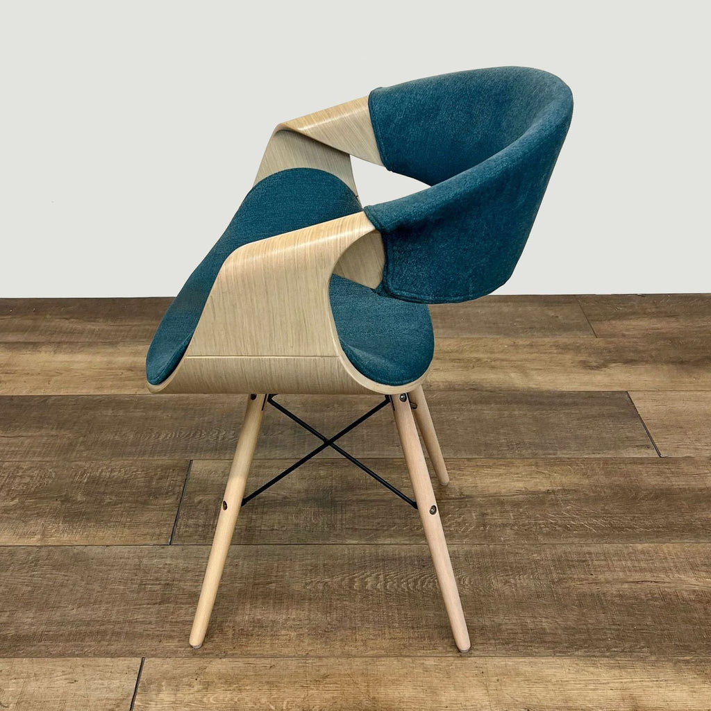 Side view of a modern accent chair with bent plywood frame and blue upholstery.