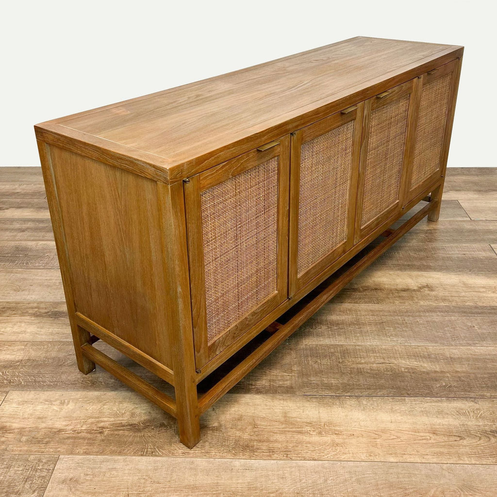 Side view of light brown teak console with handwoven rattan door panels and adjustable interior shelves.