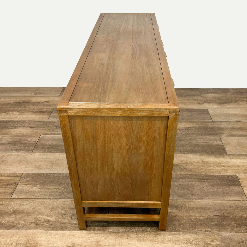 Rear angle of Crate & Barrel console highlighting teak finish and mid-century inspired design.