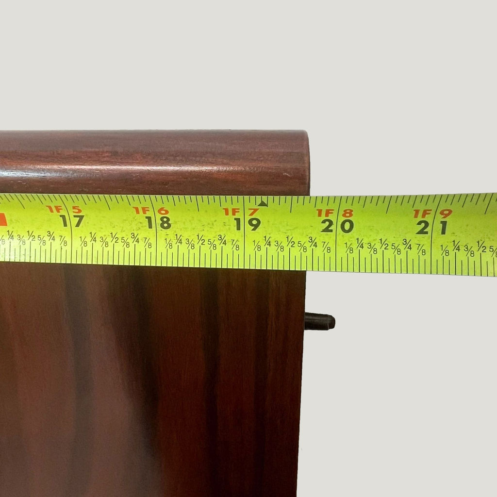 a wooden table with a green and white wooden handle 