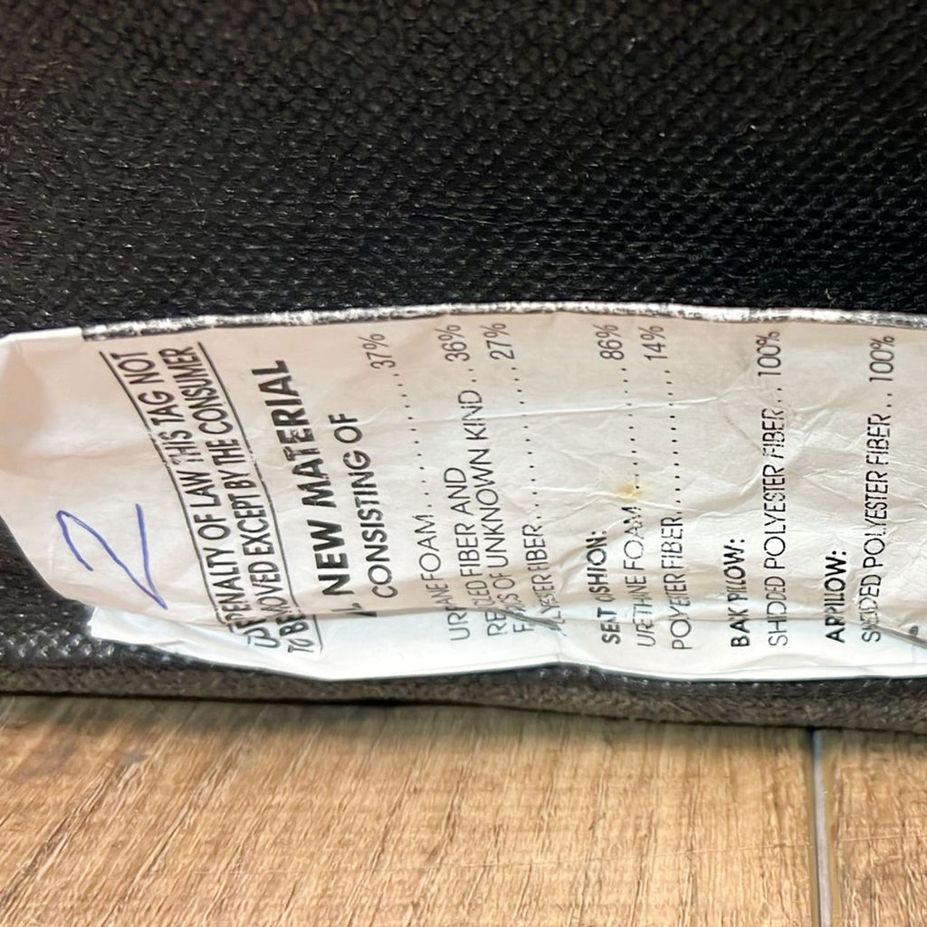 2. Close-up of product material tag listing fabric content and cushion materials for sectional, partial view visible.