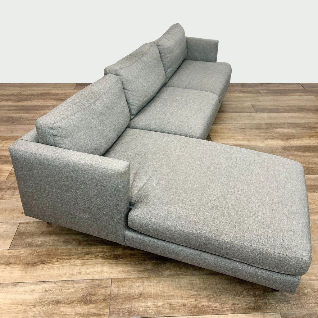 Modern graphite upholstered sectional by Room & Board with tapered wooden feet and shelter arms.