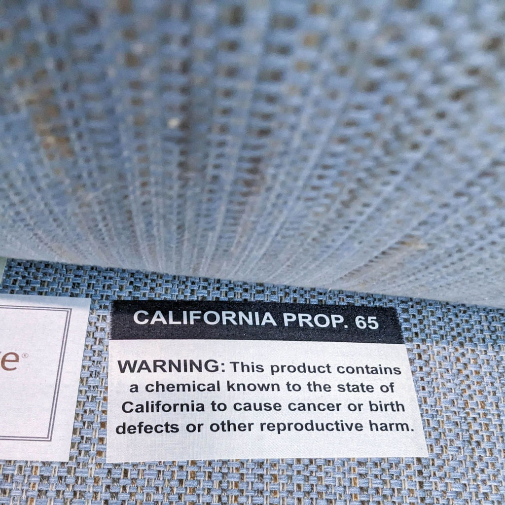 3. Close-up of a label on Kravet Furniture tweed fabric warning about chemicals known by California to cause harm.