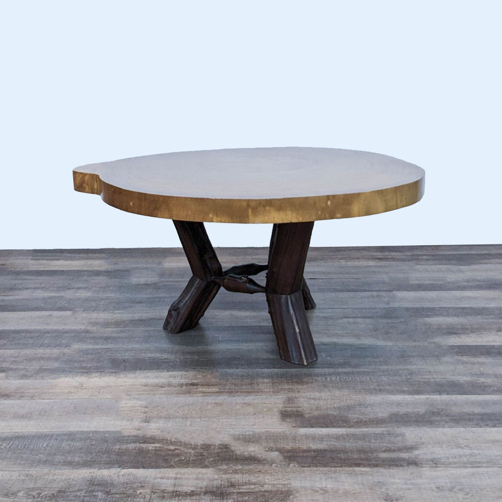 2. "Round Reperch dining table made from a Saman tree, showcasing a natural wood top and a unique tree limb base, crafted in Venezuela."