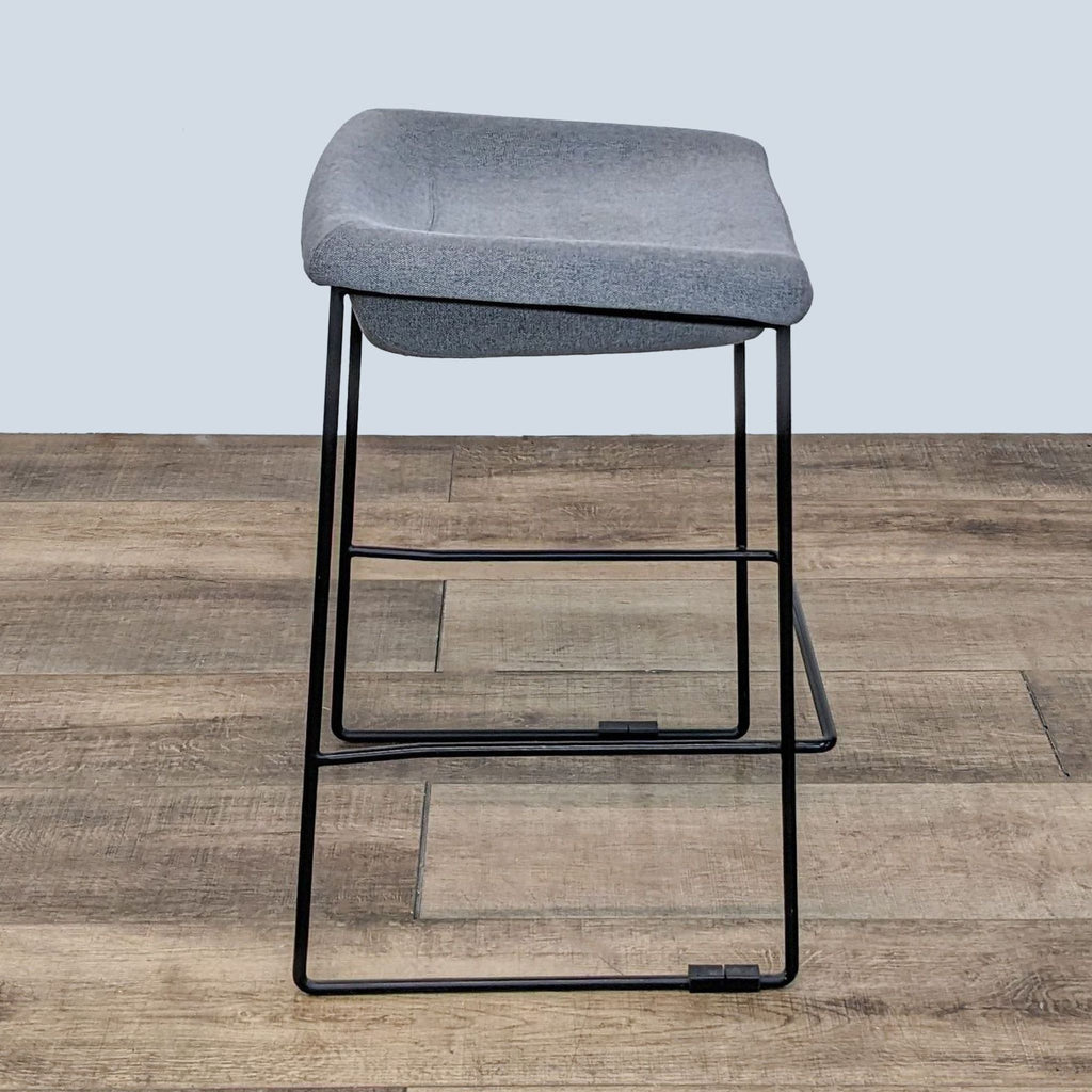 3. Contemporary EQ3 stool with square gray seat and a sturdy black metal frame, side perspective.