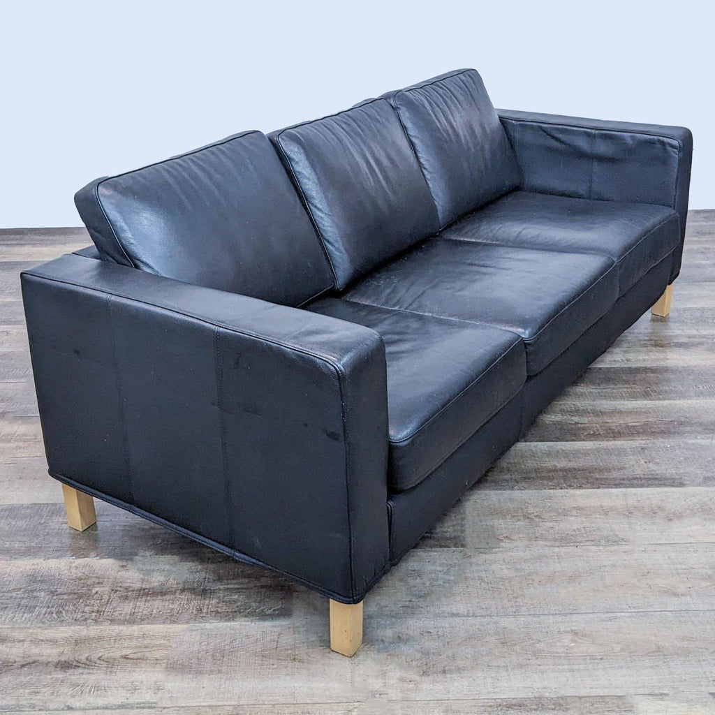 Black Reperch 3-seat sofa in a side-angle view showing cushions and armrest.