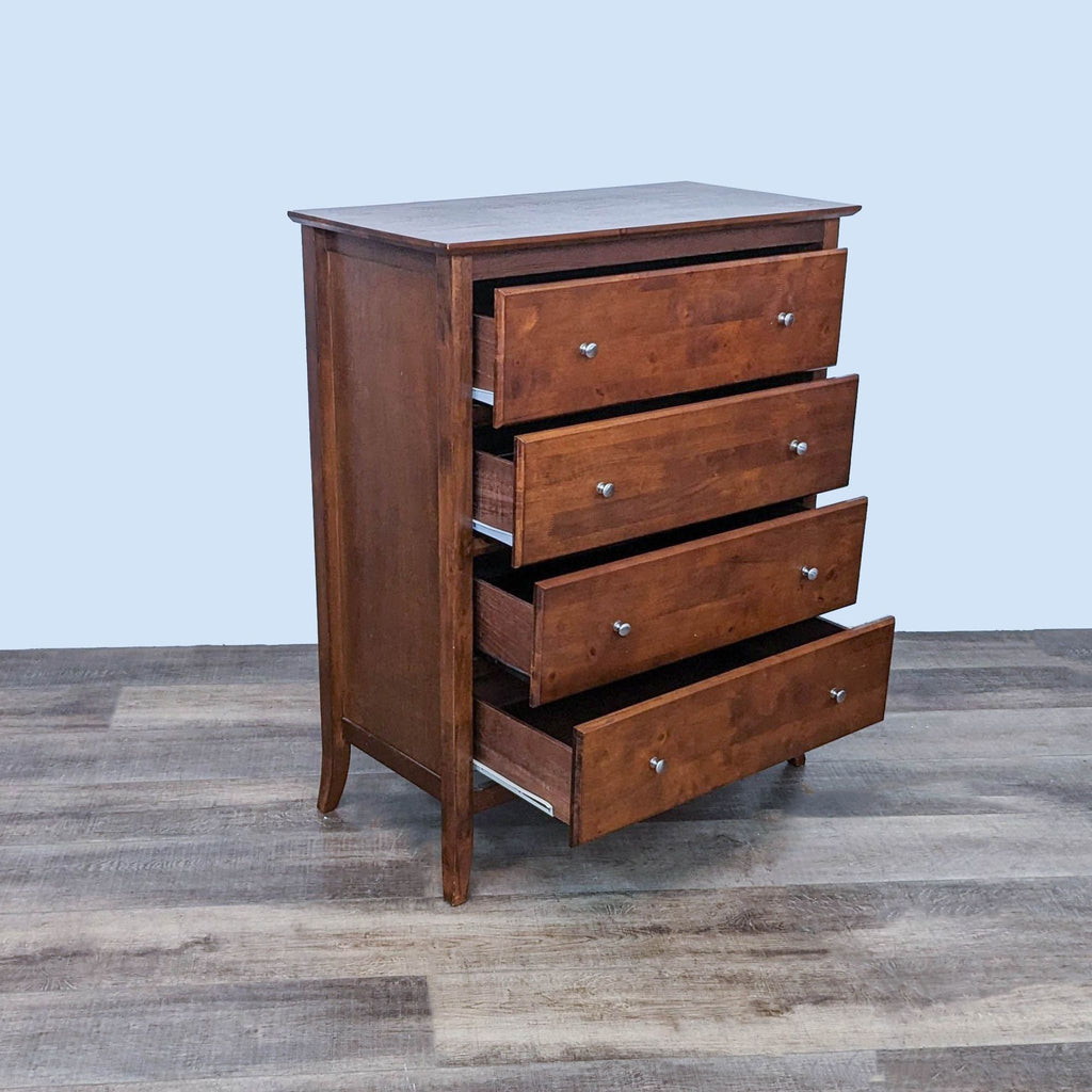 Side view of Reperch dresser showcasing open drawers with metal glides and silver knobs. 