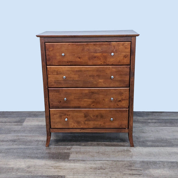 Reperch dresser with four drawers, metal glides, silver knobs, and clean lines. 