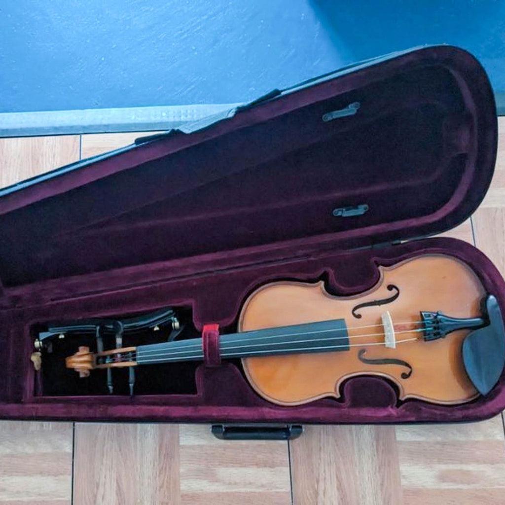 Velvet-lined hard case with a classic design violin, missing a string, and paired with a bow.