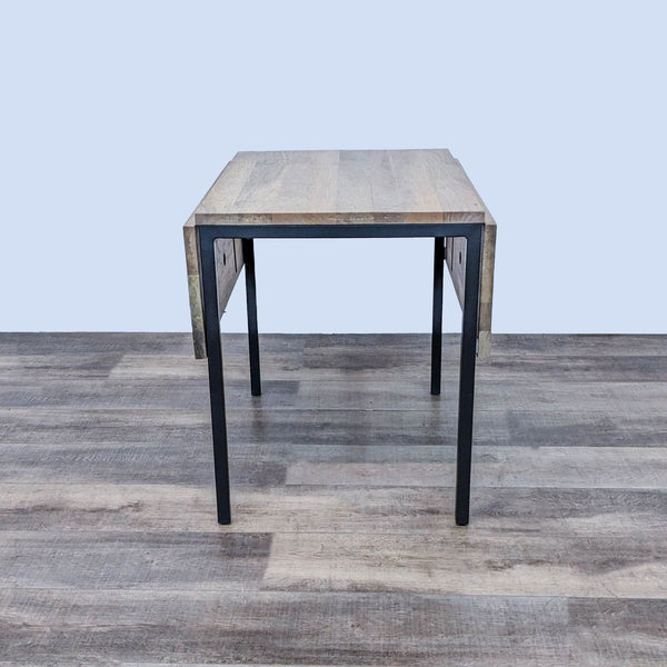 West Elm Box Frame Drop Leaf Table with sides down on wooden floor.