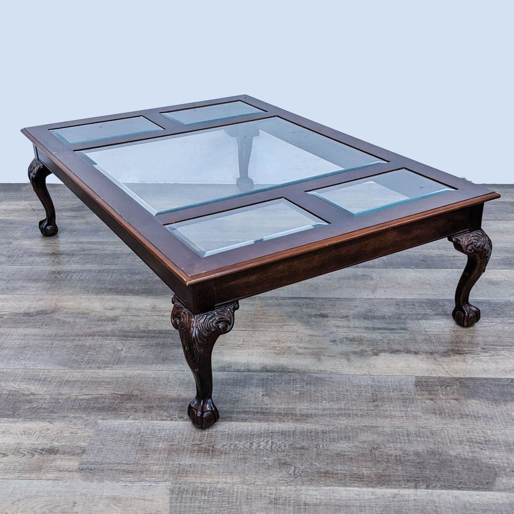 Classic Reperch coffee table featuring glass insets within a wooden frame, displayed on wood flooring.