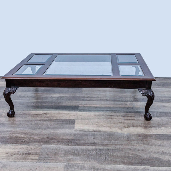 Reperch brand coffee table with beveled glass top and wooden cabriole legs from an angled view.