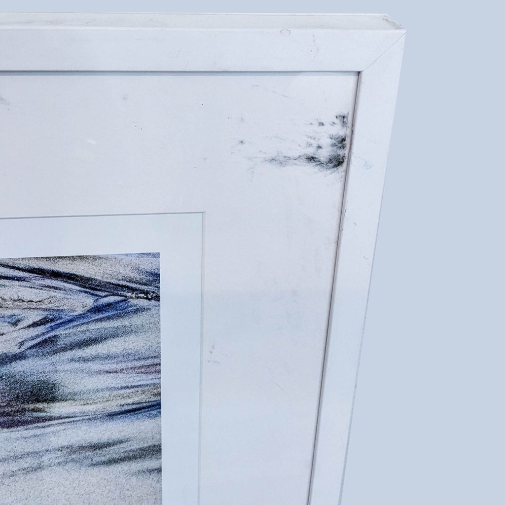 "Abstract print by Reperch with smudged blue lines, showcased in a slightly scuffed white frame."