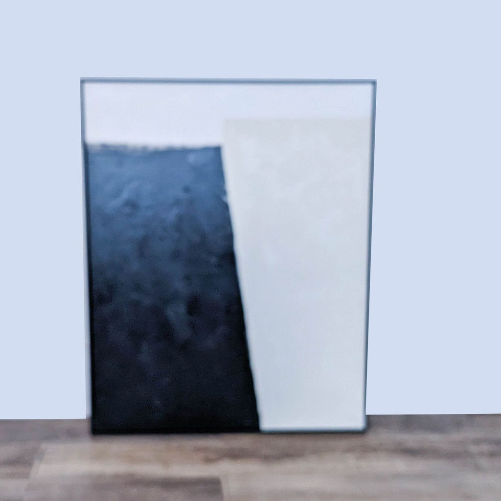 Black and white abstract canvas with hand texture framed in black. William Sonoma Home.