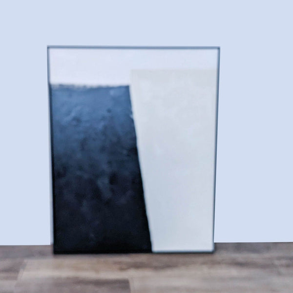 Black and white abstract canvas with hand texture framed in black. William Sonoma Home.