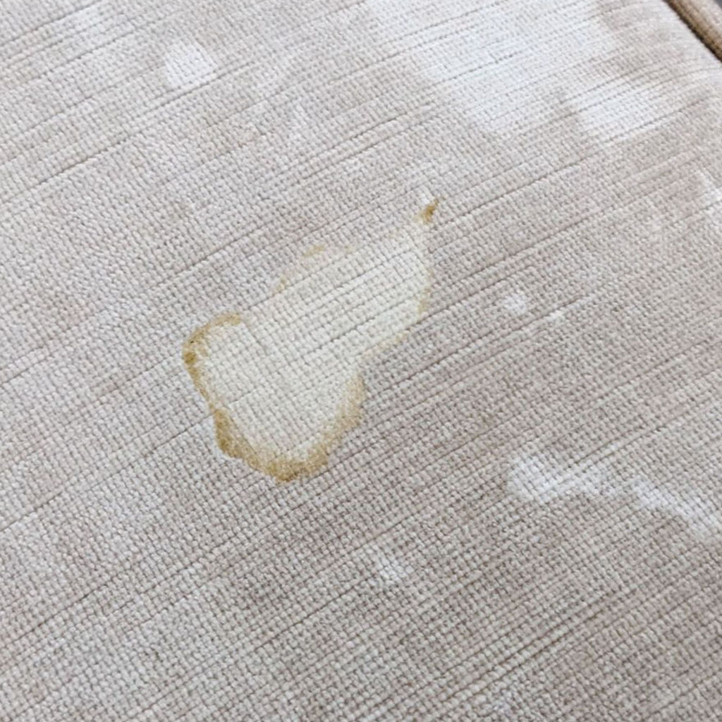 3. Close-up of a stain on a neutral-colored velvet upholstery of a Z Gallerie 3-seat sofa, showing a need for cleaning.